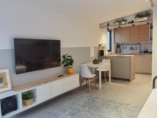 a living room with a large television on a wall at Casa Alegria in Oeiras