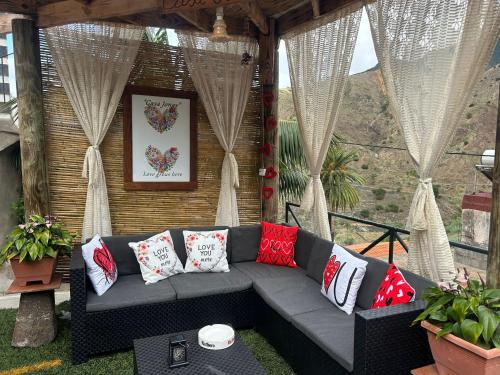 a couch sitting on a patio with pillows on it at Casa Jonay in Hermigua
