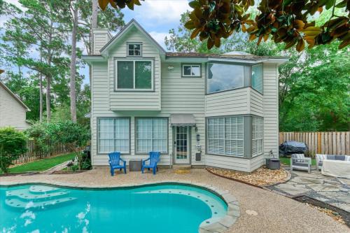 a house with a pool in front of it at The Woodlands Gem with Pool and Spa in The Woodlands