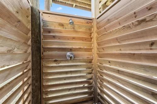 a wooden privacy fence in a wooden house at Beachfront Views with 3 bedrooms and 2 bathrooms in Bolivar Peninsula