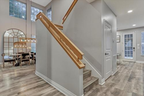 a staircase in a home with a dining room at The Woodlands Gem with Pool and Spa in The Woodlands