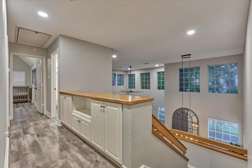 an empty kitchen with a counter and some windows at The Woodlands Gem with Pool and Spa in The Woodlands