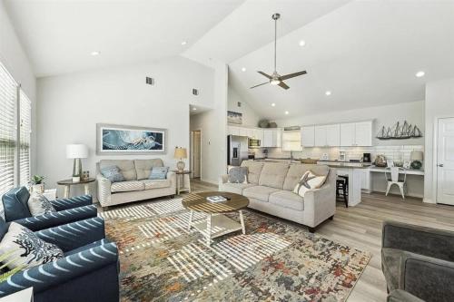 a living room with a couch and a table at Beachfront Views with 3 bedrooms and 2 bathrooms in Bolivar Peninsula
