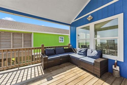 a screened in porch with a couch on a deck at Beachfront Views with 3 bedrooms and 2 bathrooms in Bolivar Peninsula