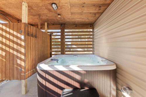 a jacuzzi tub in a room with a wooden ceiling at Work Trip in Kill Devil Hills