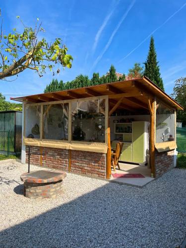 a pavilion with a brick and wooden roof at Relax home in Vonyarcvashegy