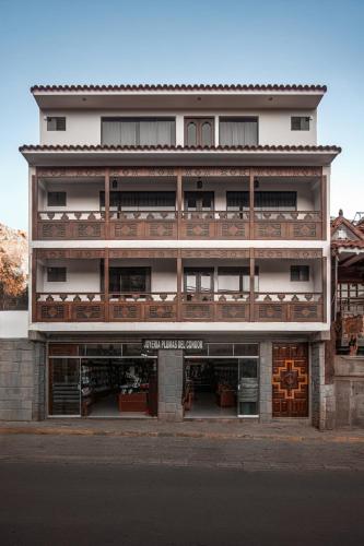 a large white building with a store front at Ayra Hotel Boutique in Pisac