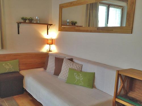 a living room with a couch and a mirror at Apartment am Wolfgangsee in Strobl