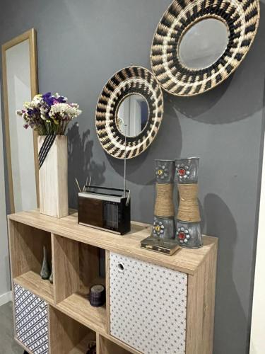 a shelf with two mirrors and a radio on a wall at Casa da Burra in Alijó