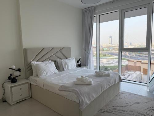 a bedroom with a large bed with towels on it at Dubai Frame Views Steps from Metro & Sheikh Zayed Road in Dubai