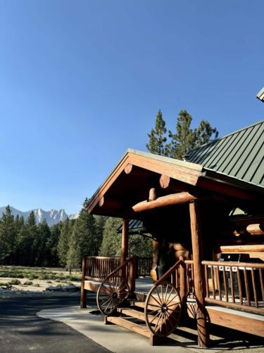 a wooden cart parked in front of a building at Peppermint Falls Ranch in Ponderosa