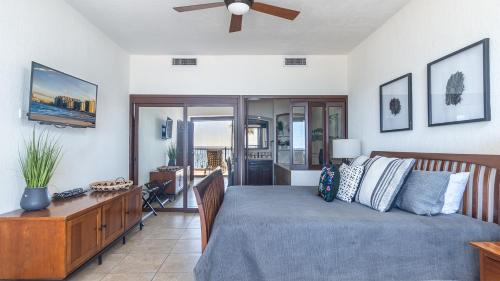 a bedroom with a bed and a ceiling fan at The Great Escape Modern Oceanfront in Puerto Peñasco