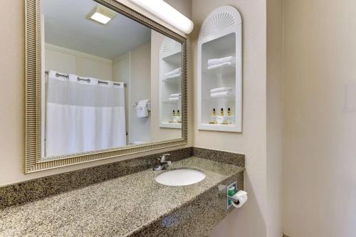 a bathroom with a sink and a mirror at Comfort Inn & Suites in Waco