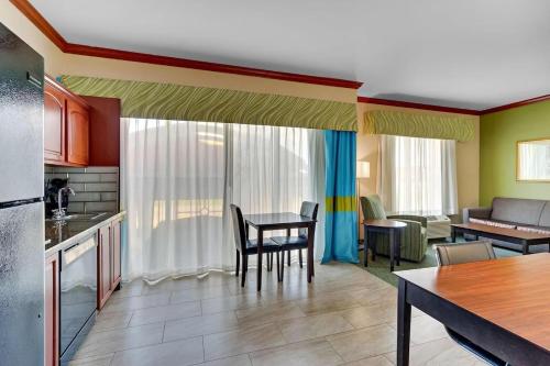 a kitchen and living room with a table and chairs at Comfort Inn & Suites in Waco