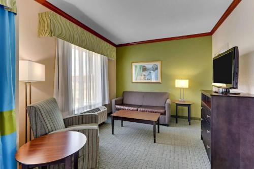 a living room with a couch and a tv at Comfort Inn & Suites in Waco