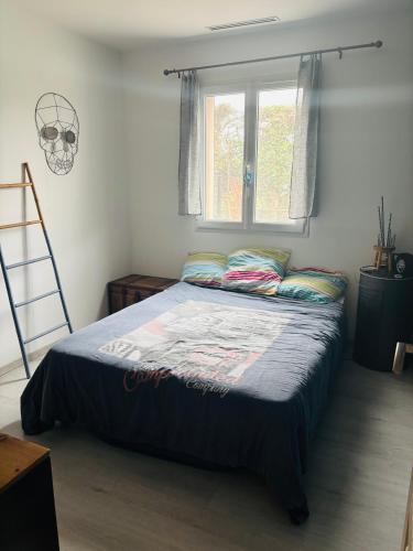 - une chambre avec un lit, une fenêtre et une échelle dans l'établissement Maison 3 chambres de Sandrine et Julien, à Saint-Privat-des-Vieux