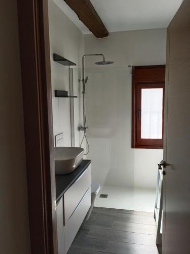 a bathroom with a sink on a counter and a window at El Rincón de San Fermín in Zizur Mayor