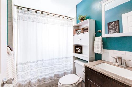 a bathroom with a toilet and a shower and a sink at Lake Huron Getaway by arc Vacation Rentals in Lexington