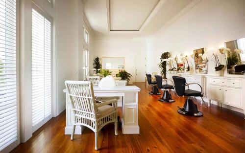 a white room with chairs and a white table at Signature 4 Bedroom Residence 1033 in Bluffton
