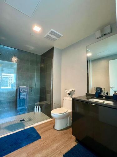 a bathroom with a shower and a toilet and a sink at The Daisy-Highrise 2BR Marina View,Pool,Jacuzzi,Gym&Parking in San Diego