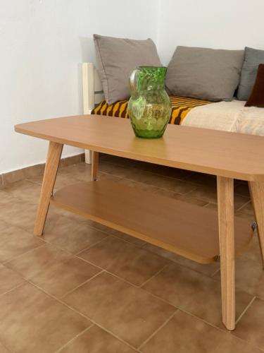 a vase sitting on top of a wooden coffee table at Tinos beauty village in Kalloní