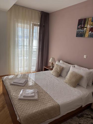 a bedroom with a large bed with two plates on it at Vila Kumani in Ohrid