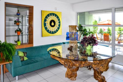 a living room with a blue couch and a glass table at Hotel Imos in Prague