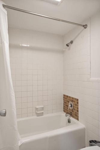 a white bathroom with a tub and a toilet at 514 Sunsuite in Fripp Island