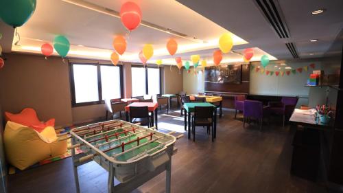 a restaurant with a pool table and tables and chairs at Libertador Hotel in Buenos Aires