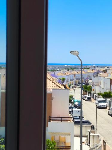 a view from a window of a city street at Quarto Apartamento em Tavira in Bicas