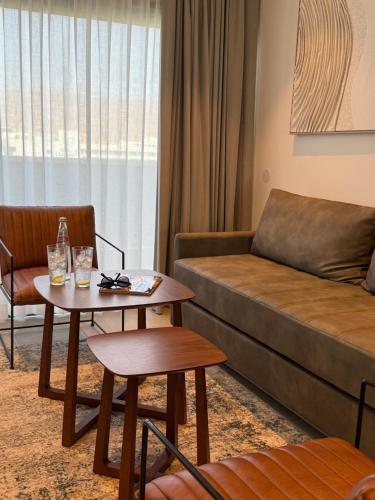 a living room with a couch and a table at Caesar Premier Eilat Hotel in Eilat