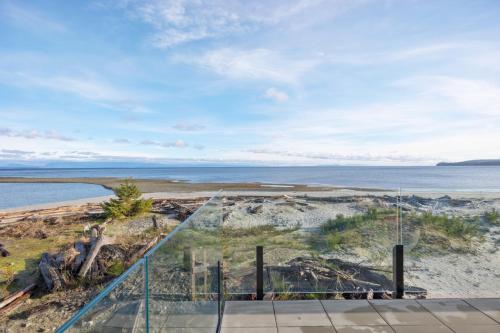 an ocean view from the balcony of a house at Beachfront Villa #14 at The Beach House in Campbell River