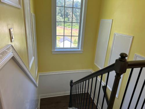 a staircase with a window and a stair case at Vacation home in Riverhead