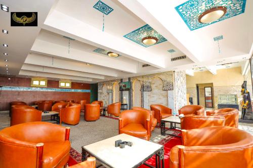 a restaurant with orange chairs and tables in a room at Comfort in Cairo