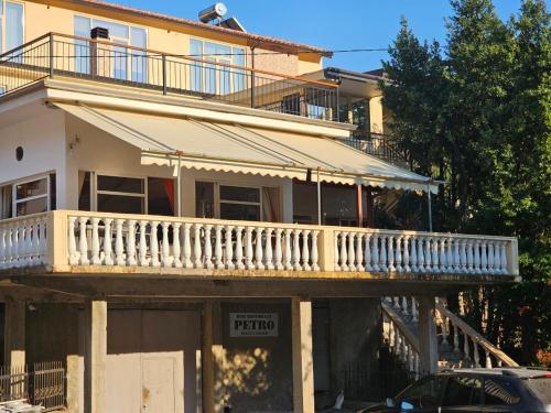 an apartment building with a balcony and a parking lot at Hotel Petro in Vlorë