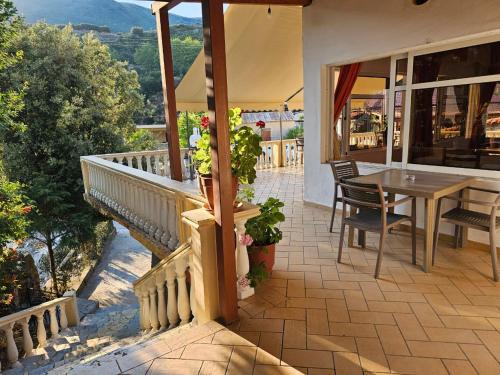 a balcony of a house with a table and chairs at Hotel Petro in Vlorë