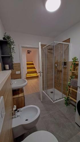 a bathroom with a toilet and a shower and a sink at Apartment in Somaggia - CasaCamillo in Riva