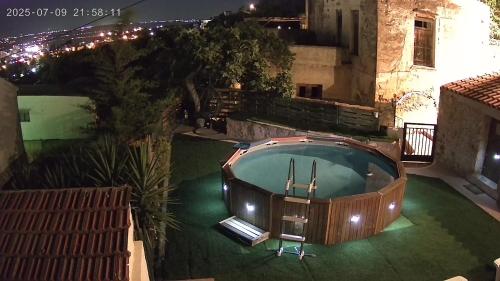 an overhead view of a swimming pool at night at Michaela's House in Tsikalariá