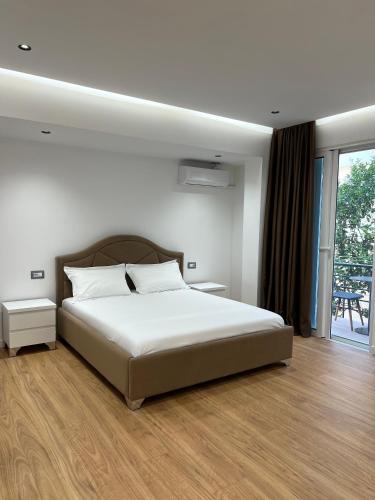 Ένα ή περισσότερα κρεβάτια σε δωμάτιο στο Poseidon Apartments