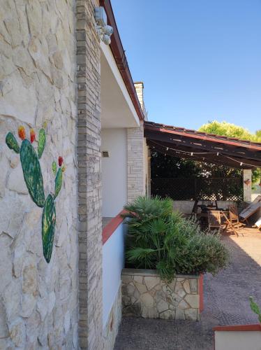 a painting of a cactus on the side of a building at Contrada Macchia B&B in Tricase