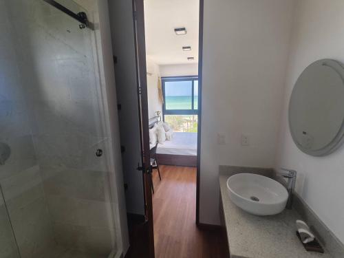 a bathroom with a sink and a shower with a mirror at Baak el Nah Seaside Heaven by LAHOS in Sisal