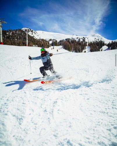 a person is skiing down a snow covered slope at AL Cosy in Vars Ski & Nature in Vars