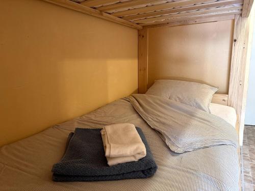 a bed with a towel sitting on top of it at AL Cosy in Vars Ski & Nature in Vars