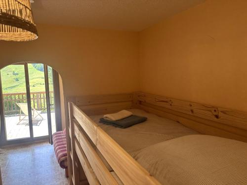 a bed in a room with a window at AL Cosy in Vars Ski & Nature in Vars