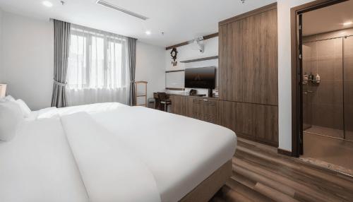 Postel nebo postele na pokoji v ubytování A25 Hotel - Hoàng Đạo Thúy 1