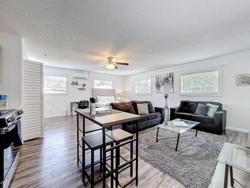 a living room with a couch and a table at Comfy Studio Farm Stay in Orlando