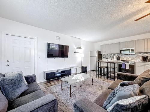 a living room with a couch and a table at Comfy Studio Farm Stay in Orlando