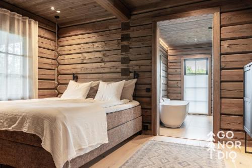 a bedroom with a bed and a bath tub at The Lazy Moose in Tällberg