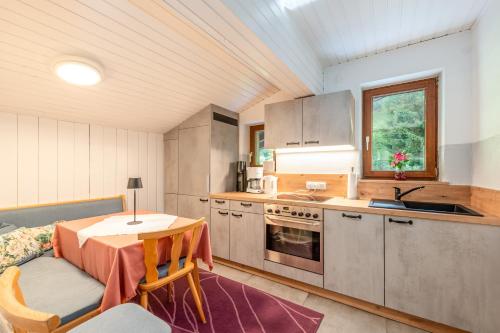 a kitchen with a table and a dining room at Fridas in Kleinarl