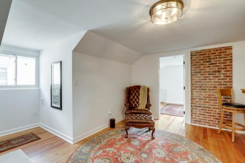a living room with a chair and a brick wall at 1 Mi to Beaches and Boardwalk Asbury Park Retreat in Asbury Park